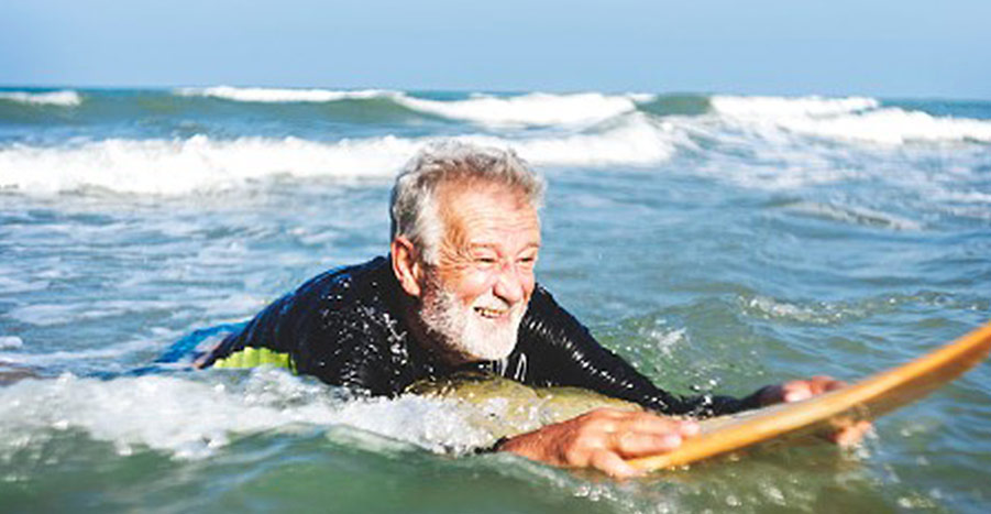 senior man on surfing board