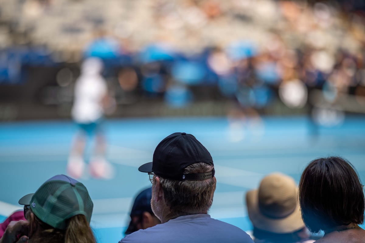 tennis fan watching a tennis match at the australian open